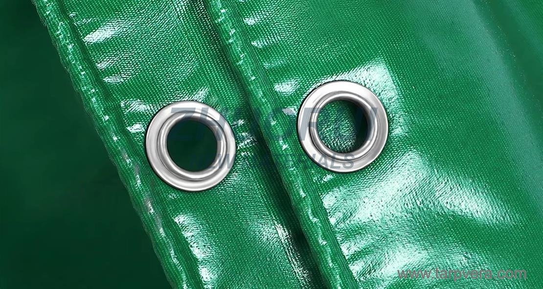 Metal eyelets on a green PVC tarpaulin