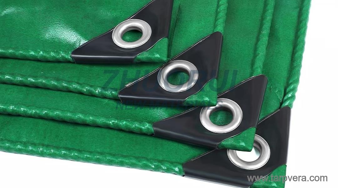Reinforced corners on a green PVC tarpaulin