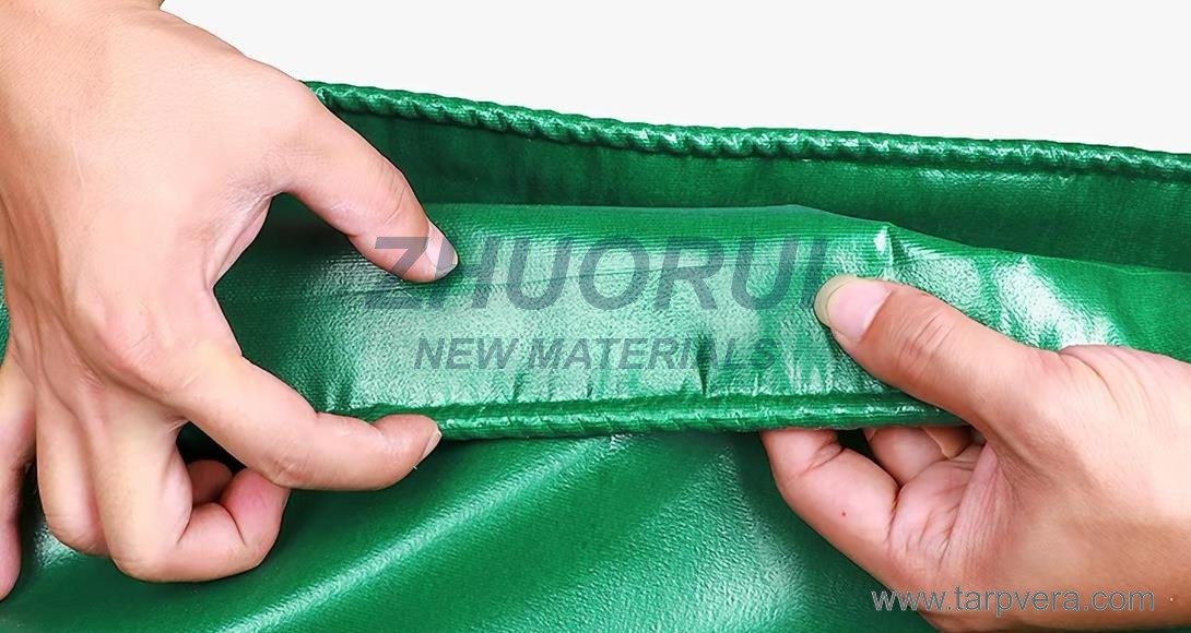 Welded seam detail on a green PVC tarpaulin