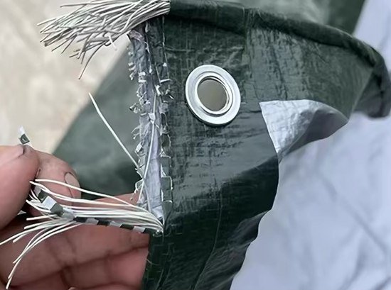 Comparison sample showing exposed woven fibres at an eyelet edge