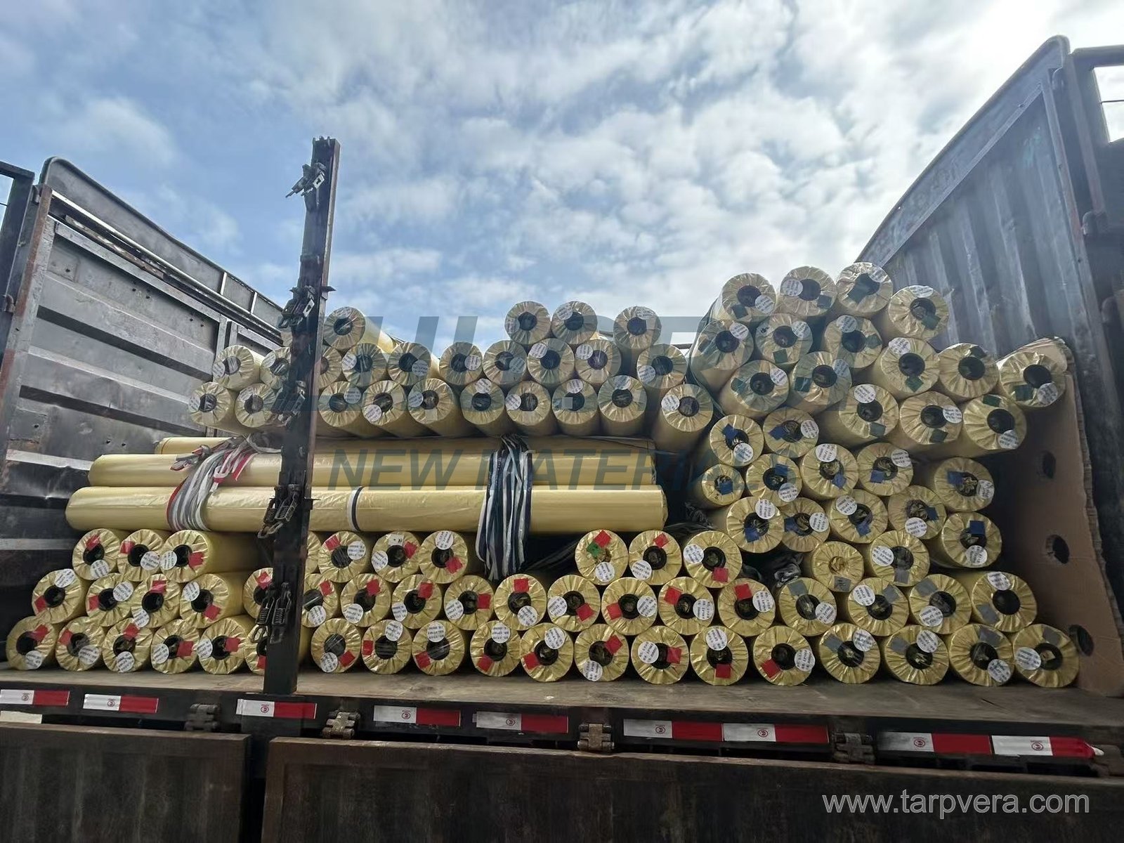 Wrapped PVC rolls loaded on an open-sided truck